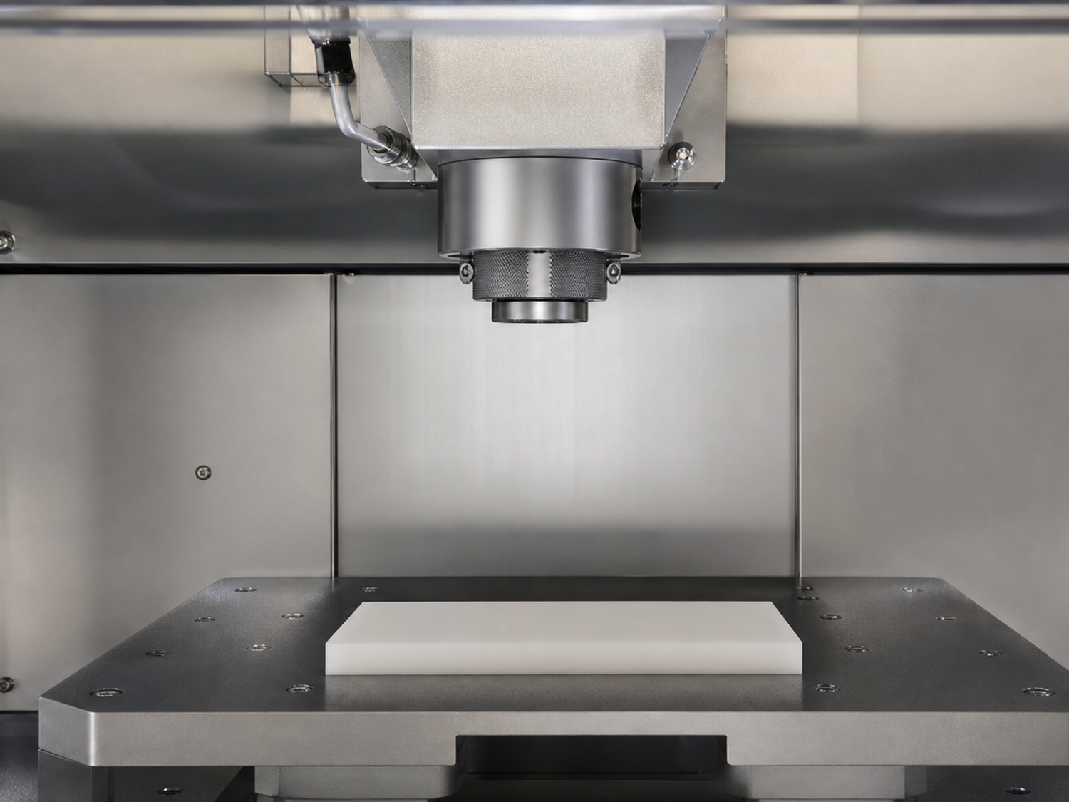 Unbranded inactive atmospheric treatment nozzle positioned above a polymer test sample